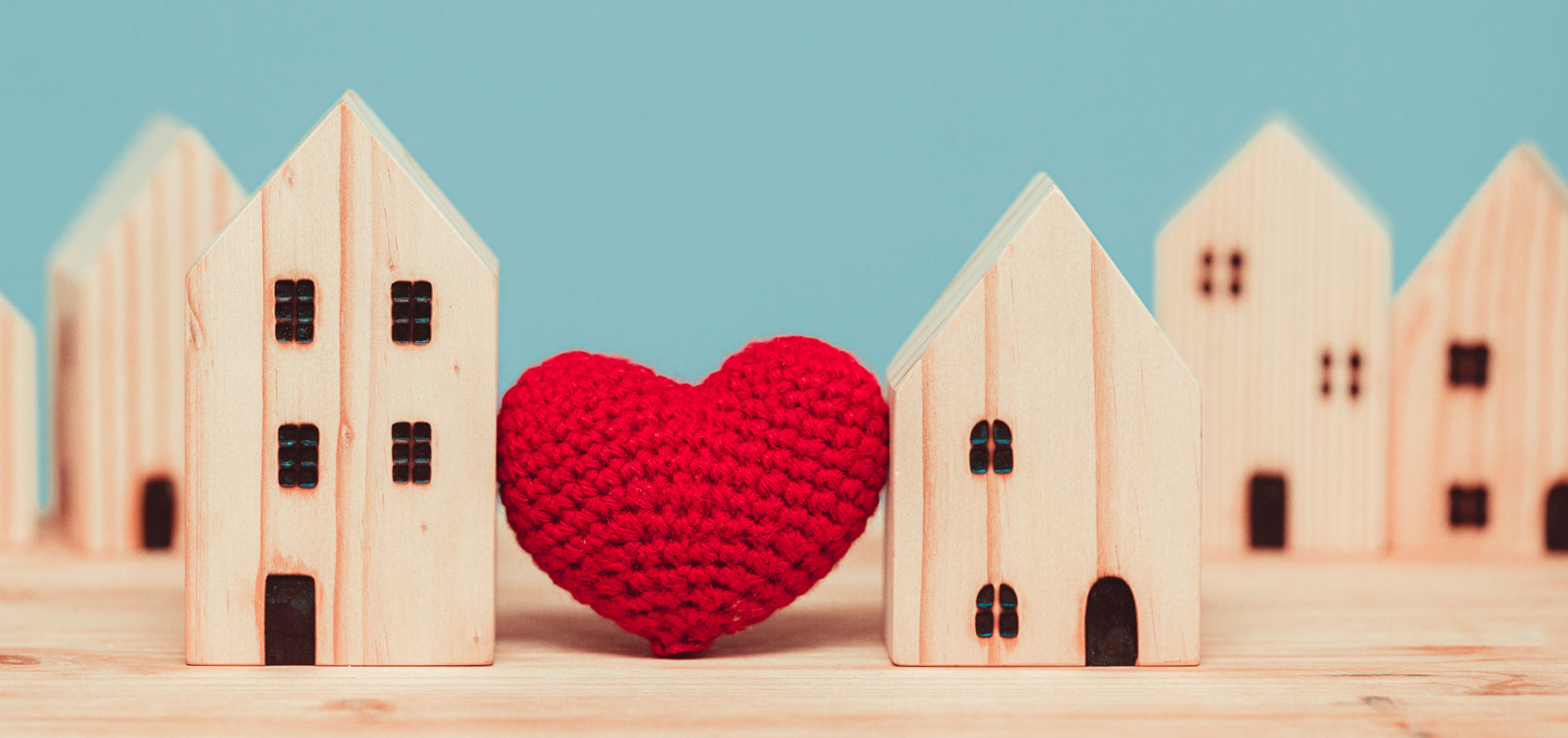 Heart between wooden houses